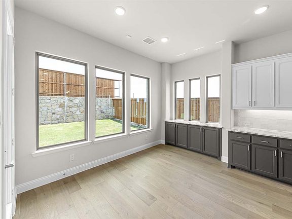 Larue floor plan by Pacesetter Homes featuring two-story living with open family and dining spaces,