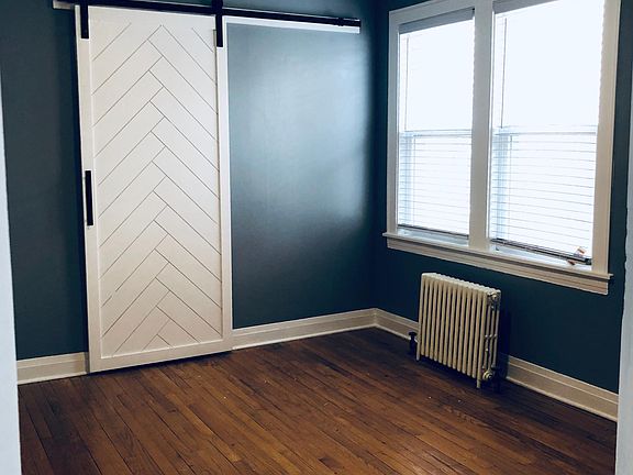 Bedroom with barn door to walk in closet