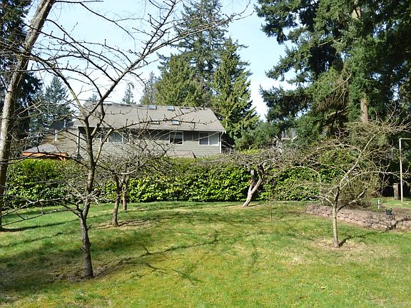 The southwest corner of the lot has a number of fruit trees and a raised garden bed.