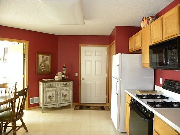 kitchen leads into large laundry room and more storage space