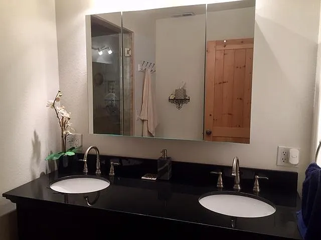 Master Suite - 2 sink on black granite vanity and triple mirrored medicine cabinet