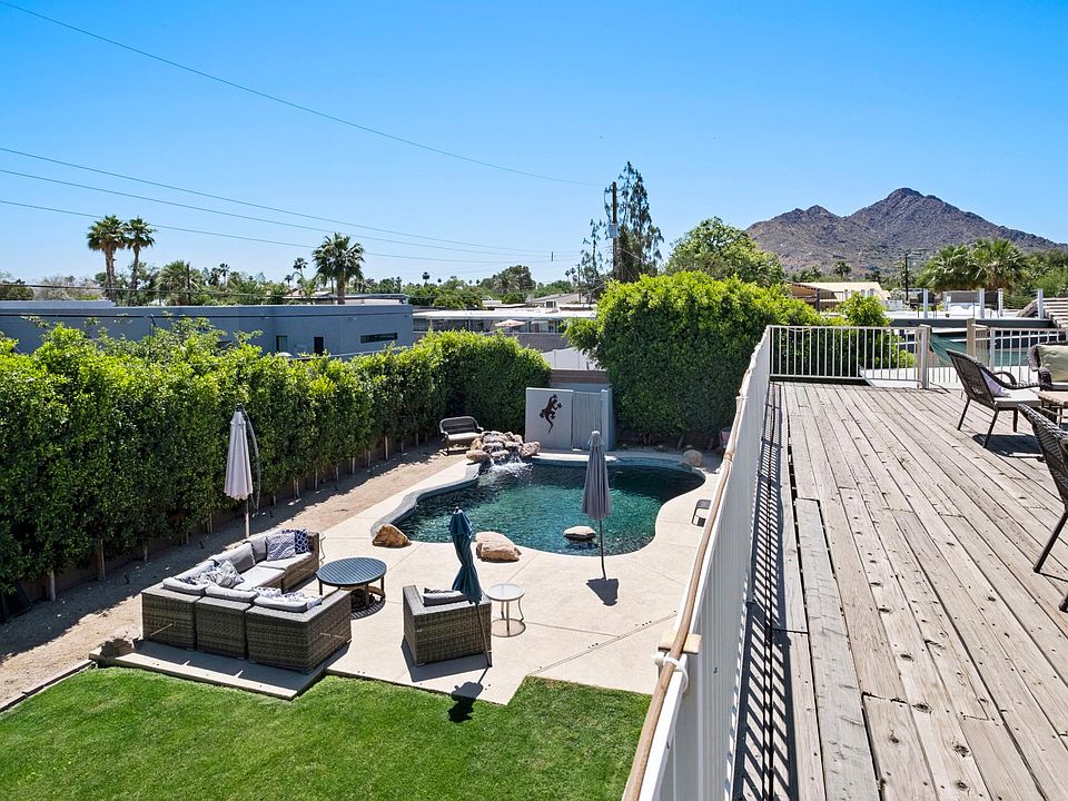 View from oversized roof top deck with seating area and dining table.