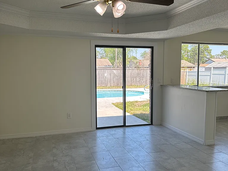 family room over look the backyard, pool and eat-in kitchen