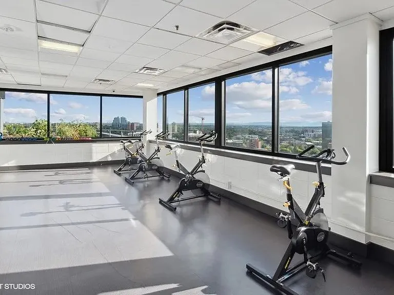 Exercise bikes with a stunning view in the fitness center at Archer Tower in Denver, CO