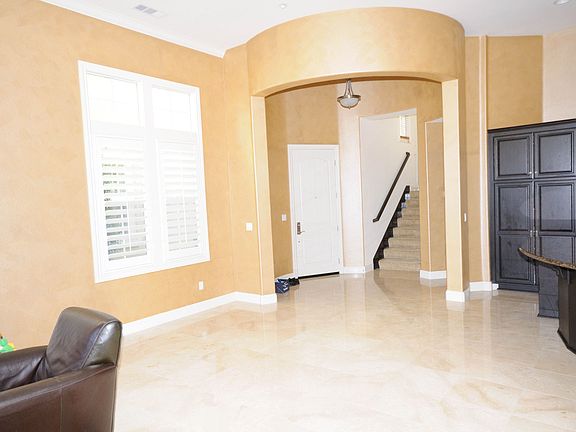 Dramatic circular foyer opens to living and dining area with 12 foot ceilings