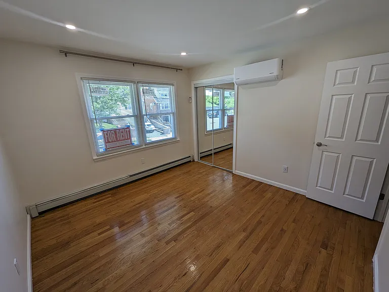 First bedroom with mirror closet.
