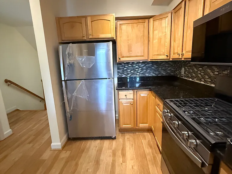 Kitchen 2: refrigerator and cabinetry