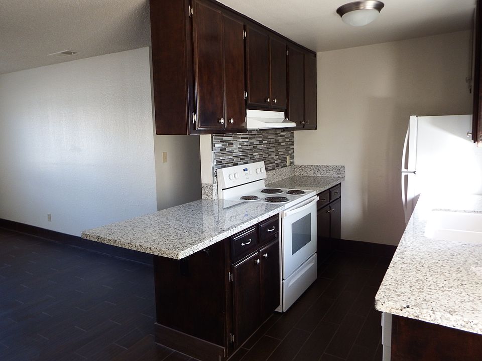 Newly stained cabinetry in rich mahogany color with modern backsplash