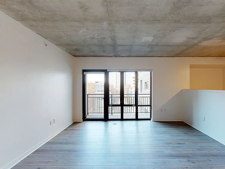 Apartment living room with wood-style flooring.