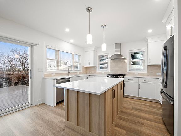 Kitchen with ocean view, eat-in island and access to large outdoor deck