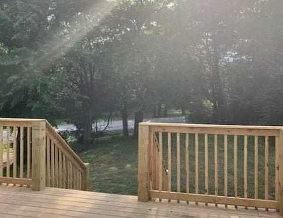 Beautiful deck that looks out to a wooded front yard.