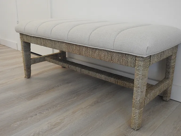 Sweet upholstered & raffia bench for easy seating in primary bedroom