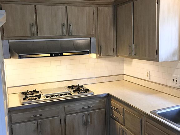 Full subway tile surround backsplash with gas range and gas wall oven. (Older image before new tile floor.)