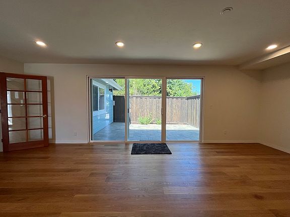 view of private, enclosed patio from living room