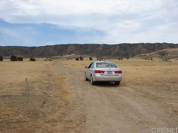 Facing south toward aquaduct and mountain range.