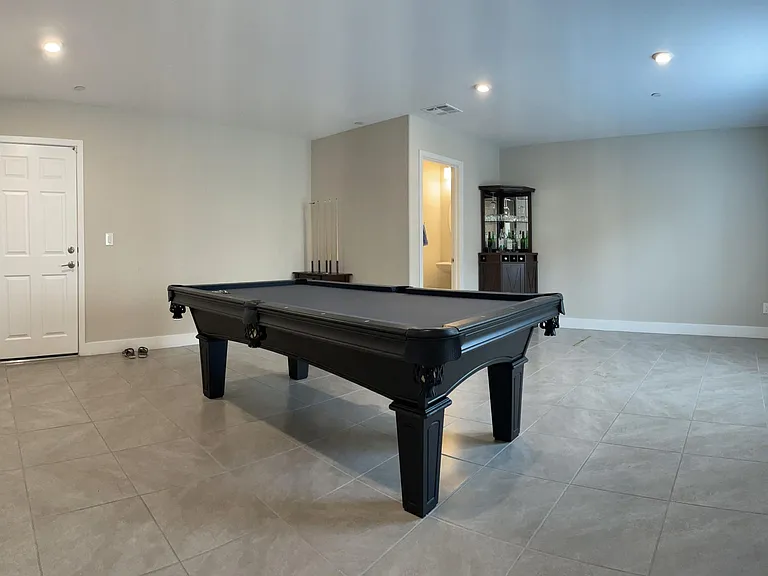 First floor for game room, man cave or exercise with en suite half bathroom, laundry and access to garage.