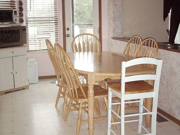eating area with bay window and door to deck