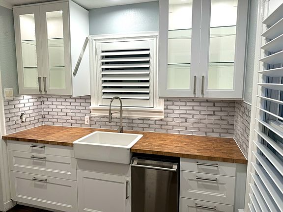 Kitchen with all new appliances, new cabinets and new windows, covered by beautiful custom plantation wood shutters.