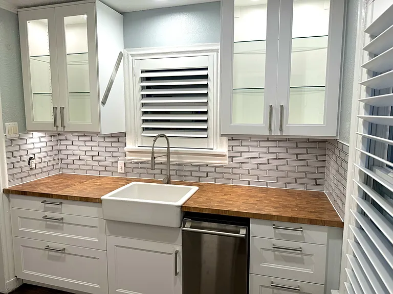 Kitchen with all new appliances, new cabinets and new windows, covered by beautiful custom plantation wood shutters.