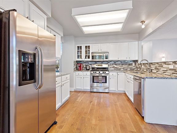 Wow how that kitchen sparkles! Great kitchen to have friends and family over to entertain its spacious and open!