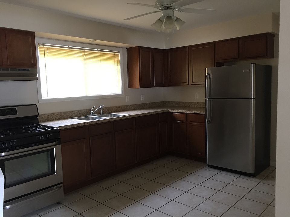 newer kitchen with stainless steel frig & gas stove