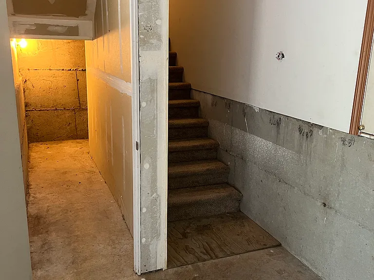 Garage storage room stairs lead to main floor