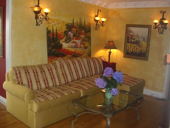 This is a great living room space where all the walls have now been painted white. There is crown molding in this room with beautiful wall counselors, all dimmable, and you face the fireplace for a warm cozy evening.