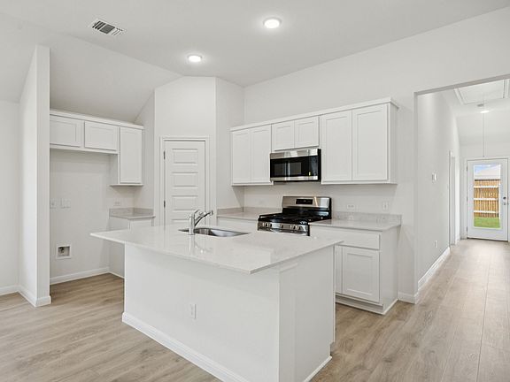 Kitchen in the Cypress home plan by Trophy Signature Homes - REPRESENTATIVE PHOTO