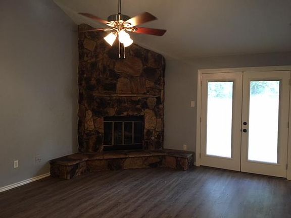 Living room with gas fireplace and french doors opening to the backyard.