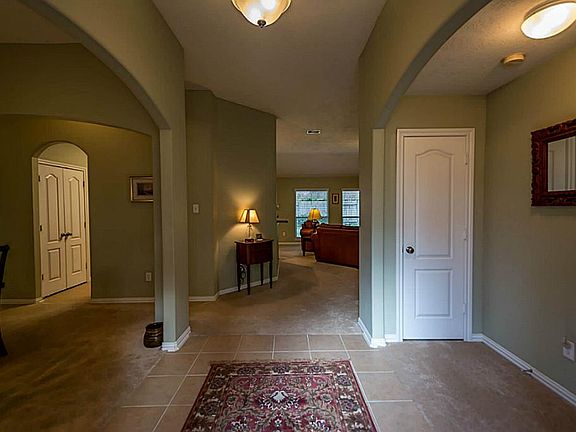 Spacious foyer entry onto ceramic tile. There is plenty of storage with one coat closet in view and two more closets near the laundry room.
