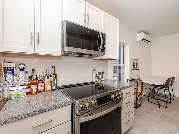 Professionally designed eat-in kitchen with custom cabinets.