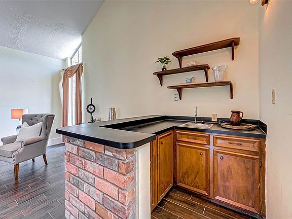 View of the wet bar from the entryway offering plenty of storage cabinets.
