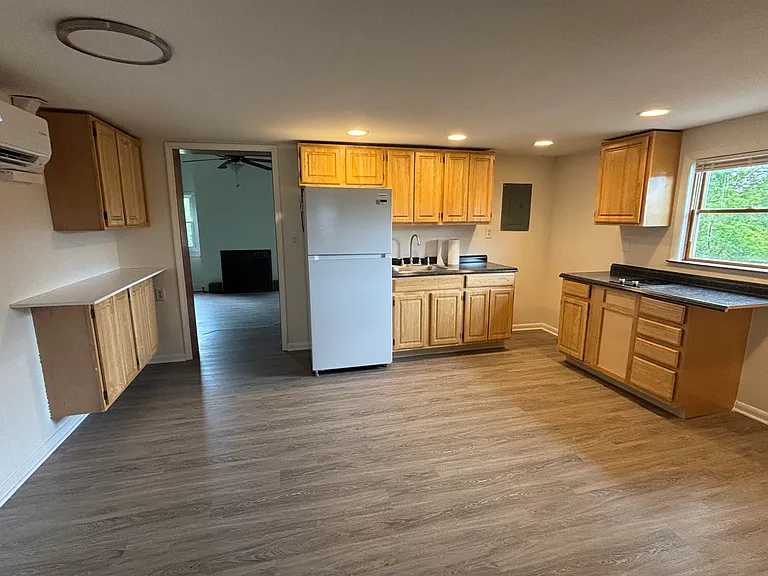 Eat in kitchen with pantry and coffee bar. Includes new refrigerator and two-burner cooktop.