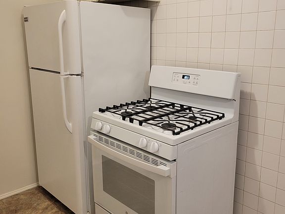 Full-sized refrigerator and gas stove included.