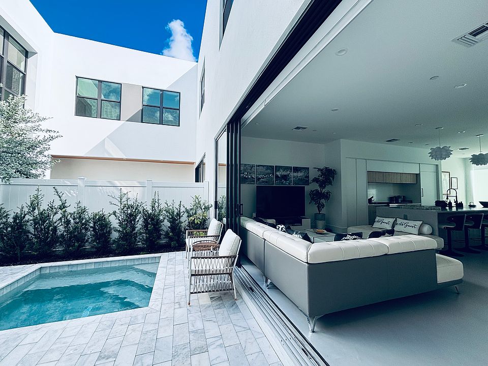 The sliding glass doors can be fully opened, seamlessly blending indoor and outdoor spaces.