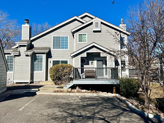Detatched garage and multiple parking spaces directly in front of the three-floor townhome