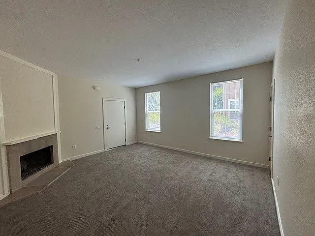 Living room with wood fireplace.