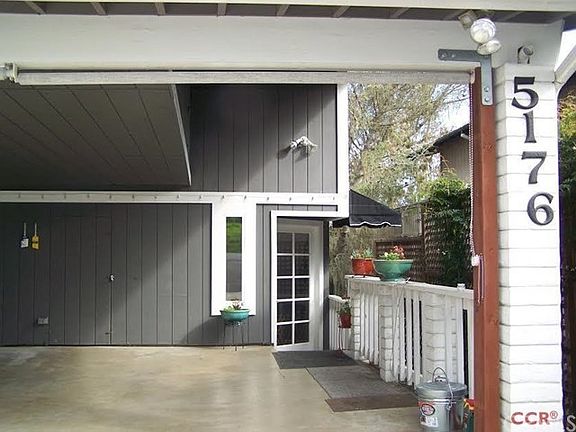 Entry porch, and attic storage above carport.