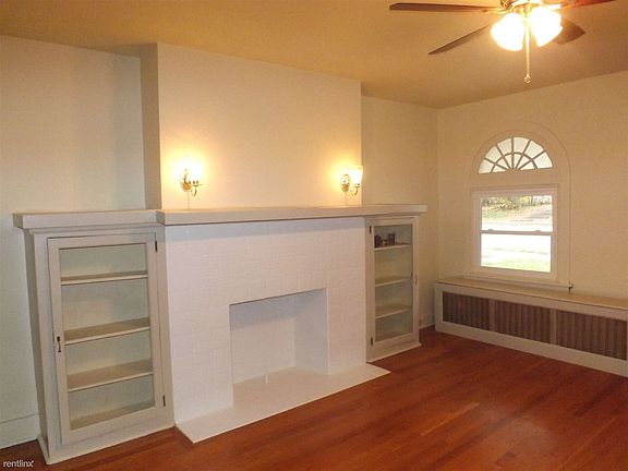Living room also has decorative fireplace and built ins.