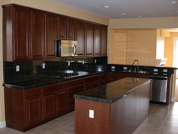 Huge kitchen with granite counter tops and stainless steel appliances 
