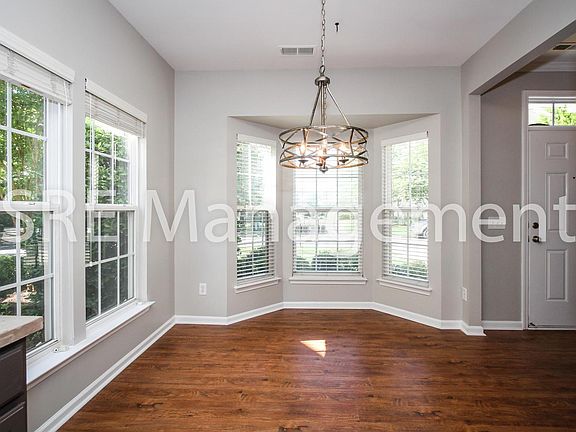 Breakfast nook anchored by bay window.