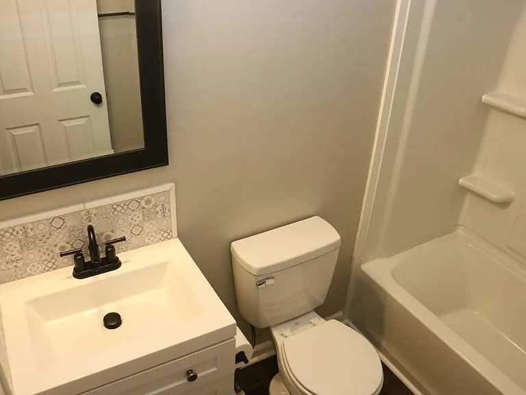 Tiled backsplashes behind all bathroom and kitchen sinks