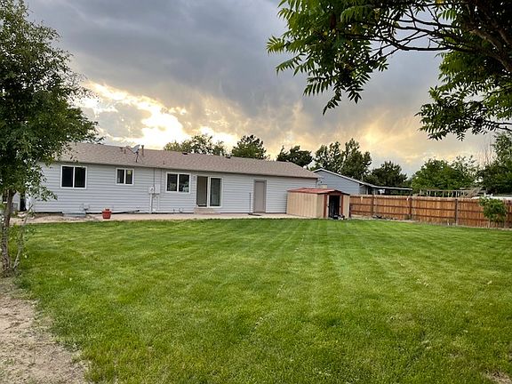 Large grassy backyard with room for a garden and toys