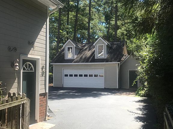 Right side of house with driveway leading to the two car garage and shed. With upstairs storage