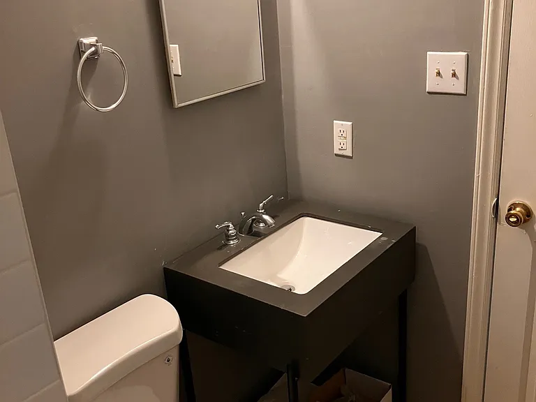 Master bath with standing tiled shower.