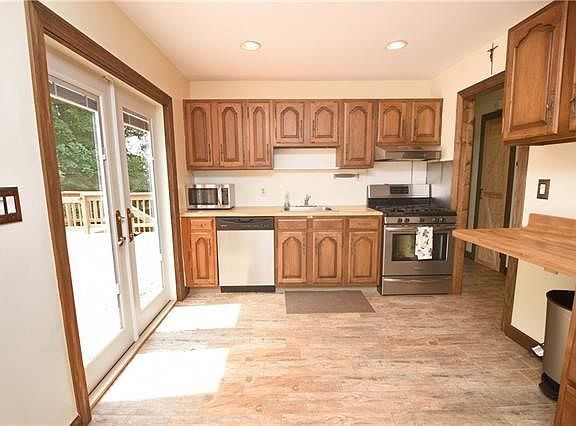 Large kitchen with updated appliances with french door to deck.