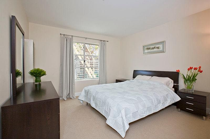 Bedroom holds king-sized bed, two nightstands, and a dresser