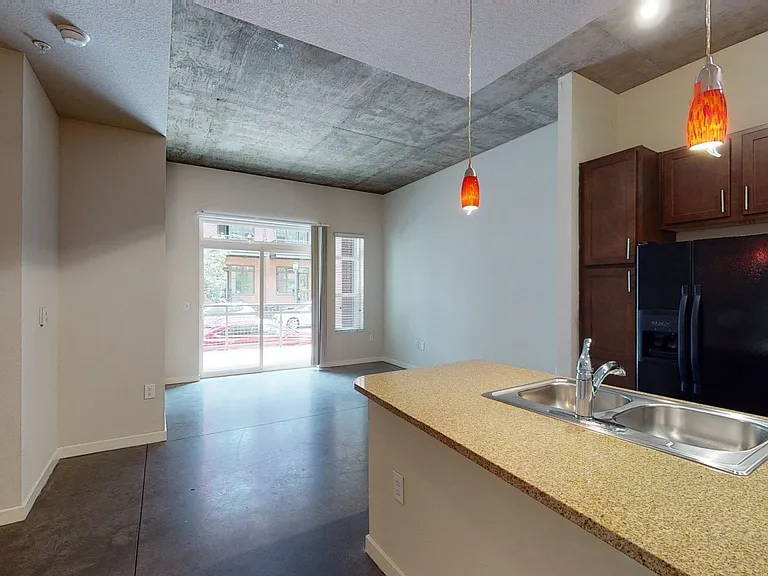 Apartment living room with polished concrete flooring.
