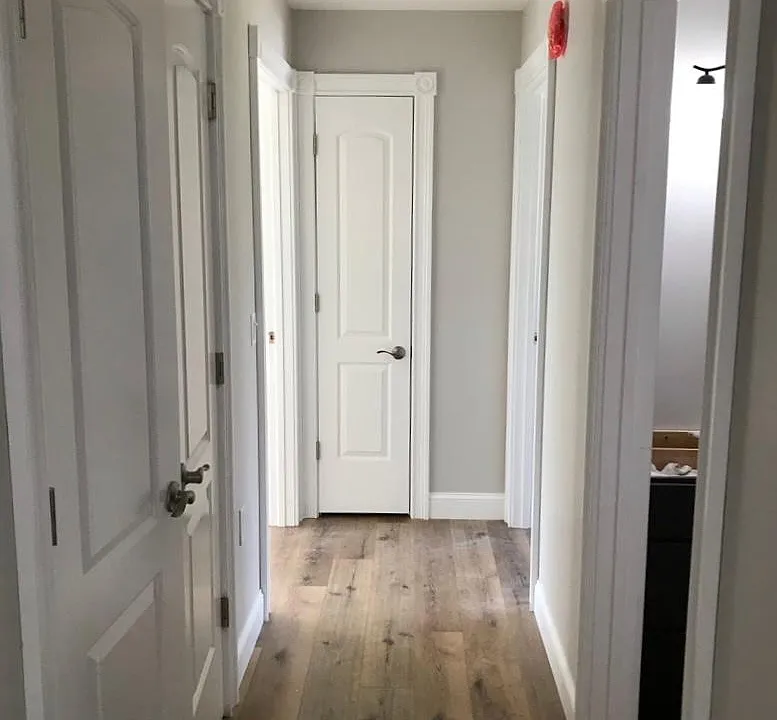 hallway closet on left, bathroom on immediate right, bedrooms located on left and right at end of hallway, with linen closet straight ahead