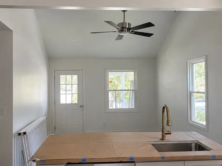 View of living room from kitchen. 
*AI was used to remove construction clutter from image.